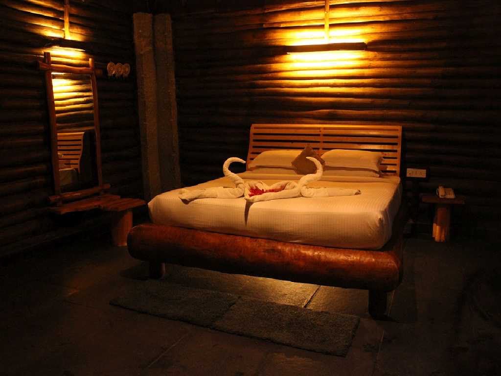 Wooden Log Cottage accommodation at Mango Mist Resorts, Bengaluru