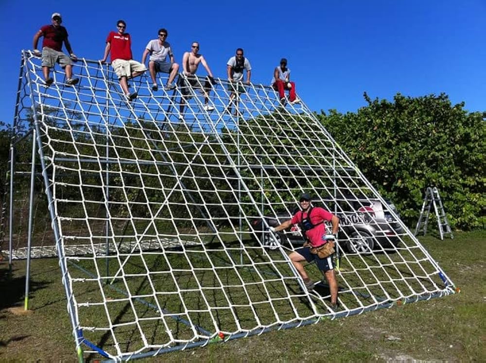 Climber navigating natural-textured artificial rock climbing wall
